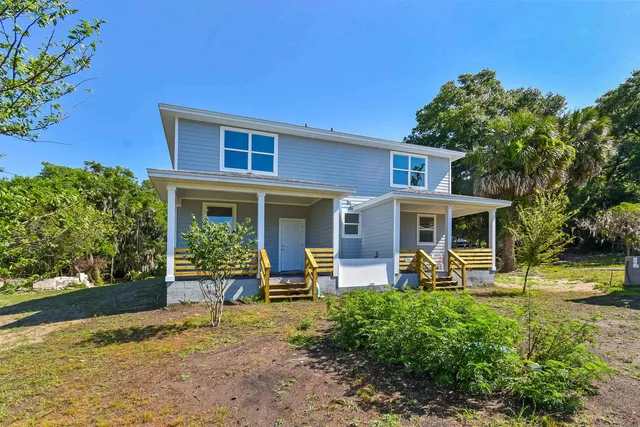 a front view of a house with outdoor seating