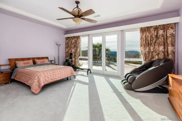 a bedroom with a large bed and a large window