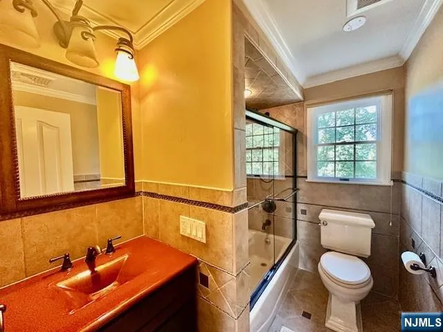 a bathroom with a sink toilet and a mirror