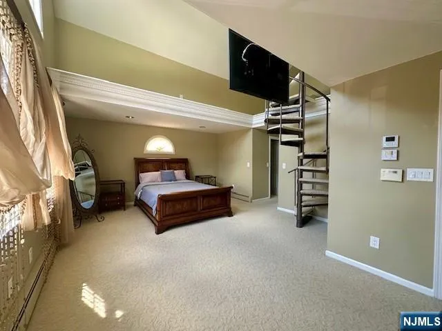 a bed room with a bed and a television