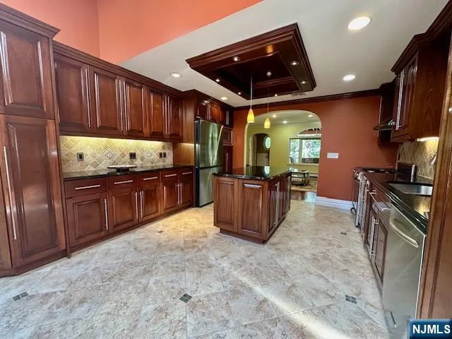 a kitchen with granite countertop a sink and a stove top oven