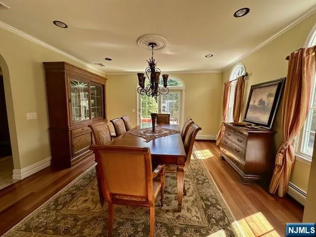 a dining room with furniture a rug and wooden floor