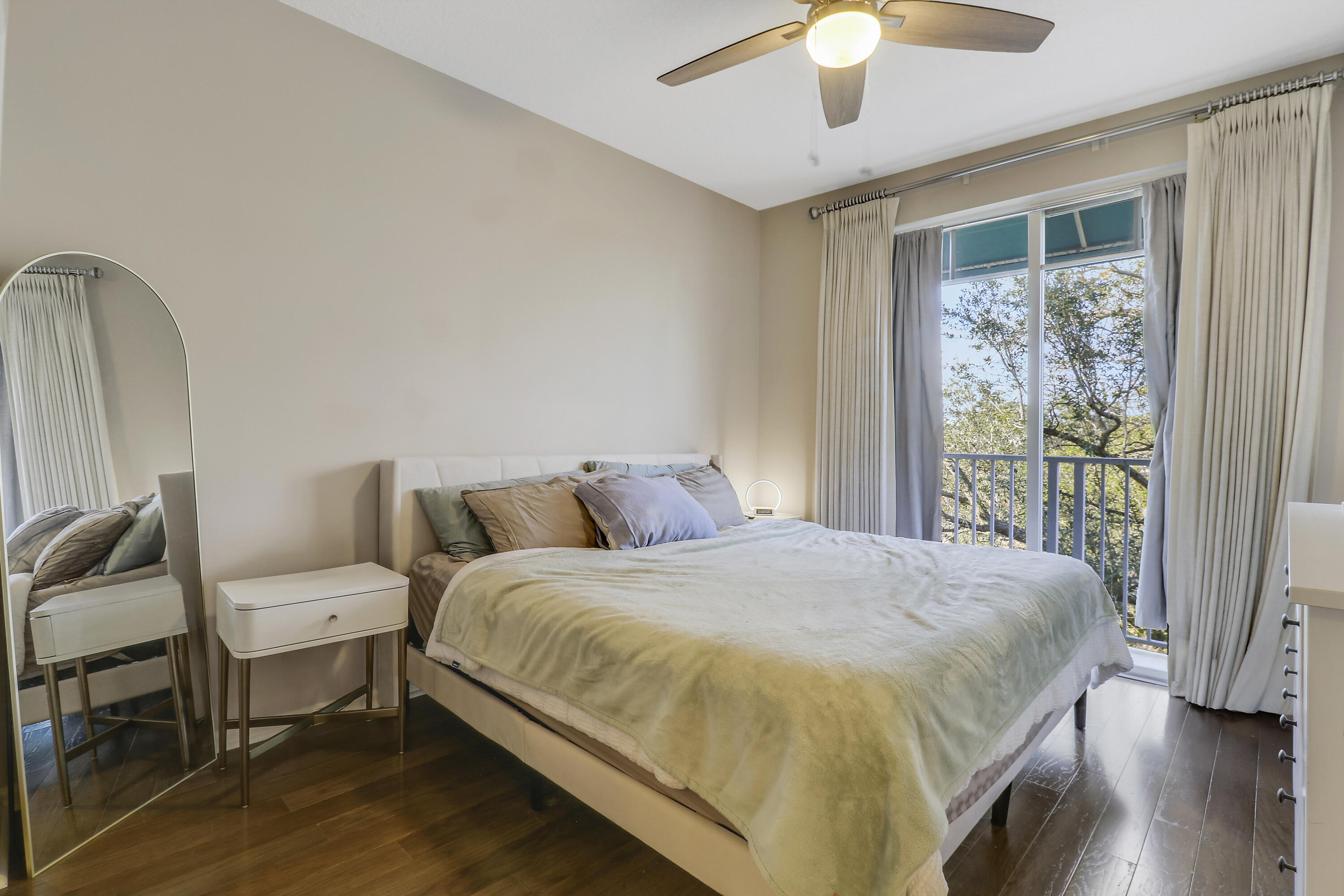 1152 University Boulevard, Unit 22 Jupiter, FL 33458 - Photo 13 of 24 a spacious bedroom with a bed and a chandelier