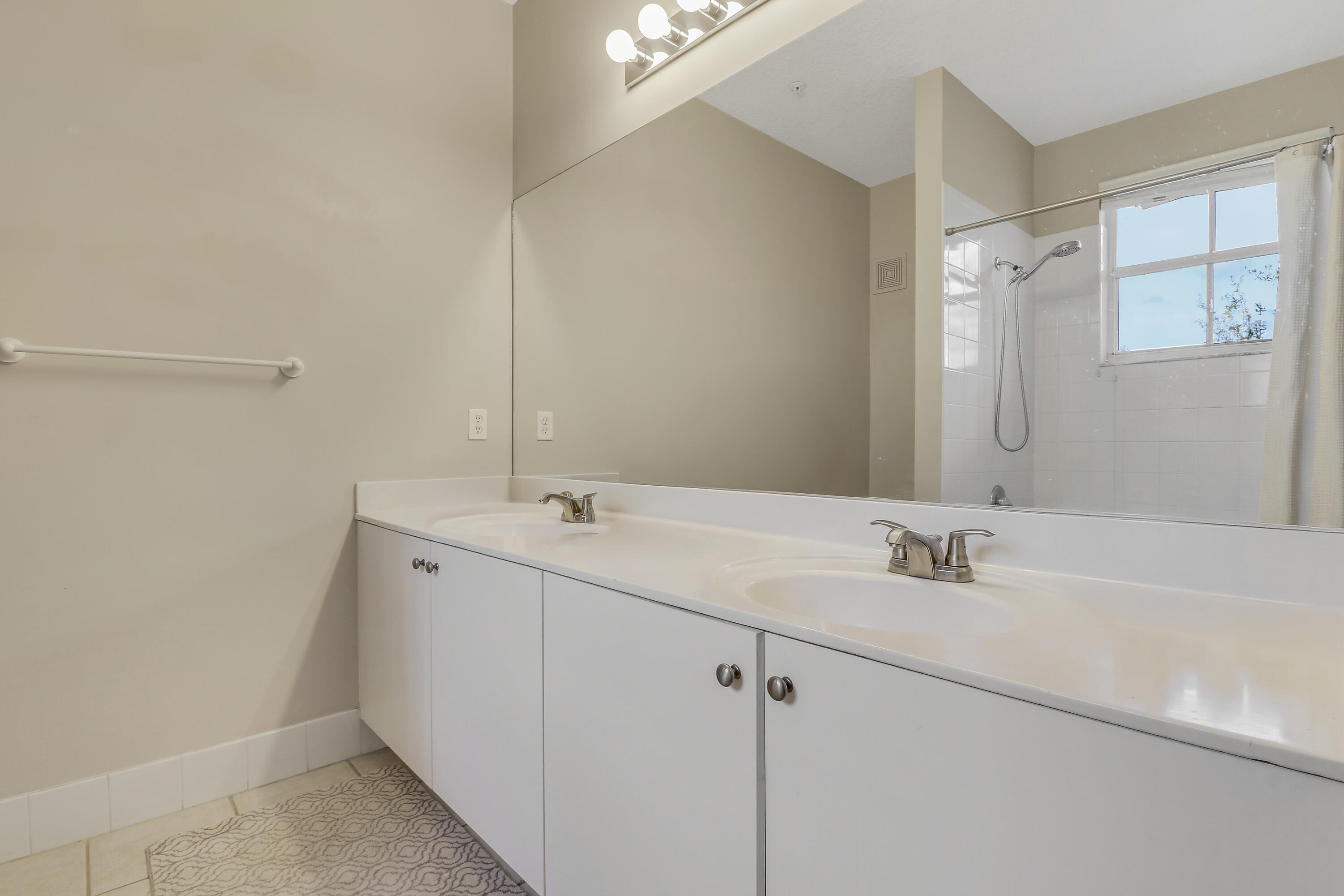1152 University Boulevard, Unit 22 Jupiter, FL 33458 - Photo 15 of 24 a bathroom with a sink and a mirror