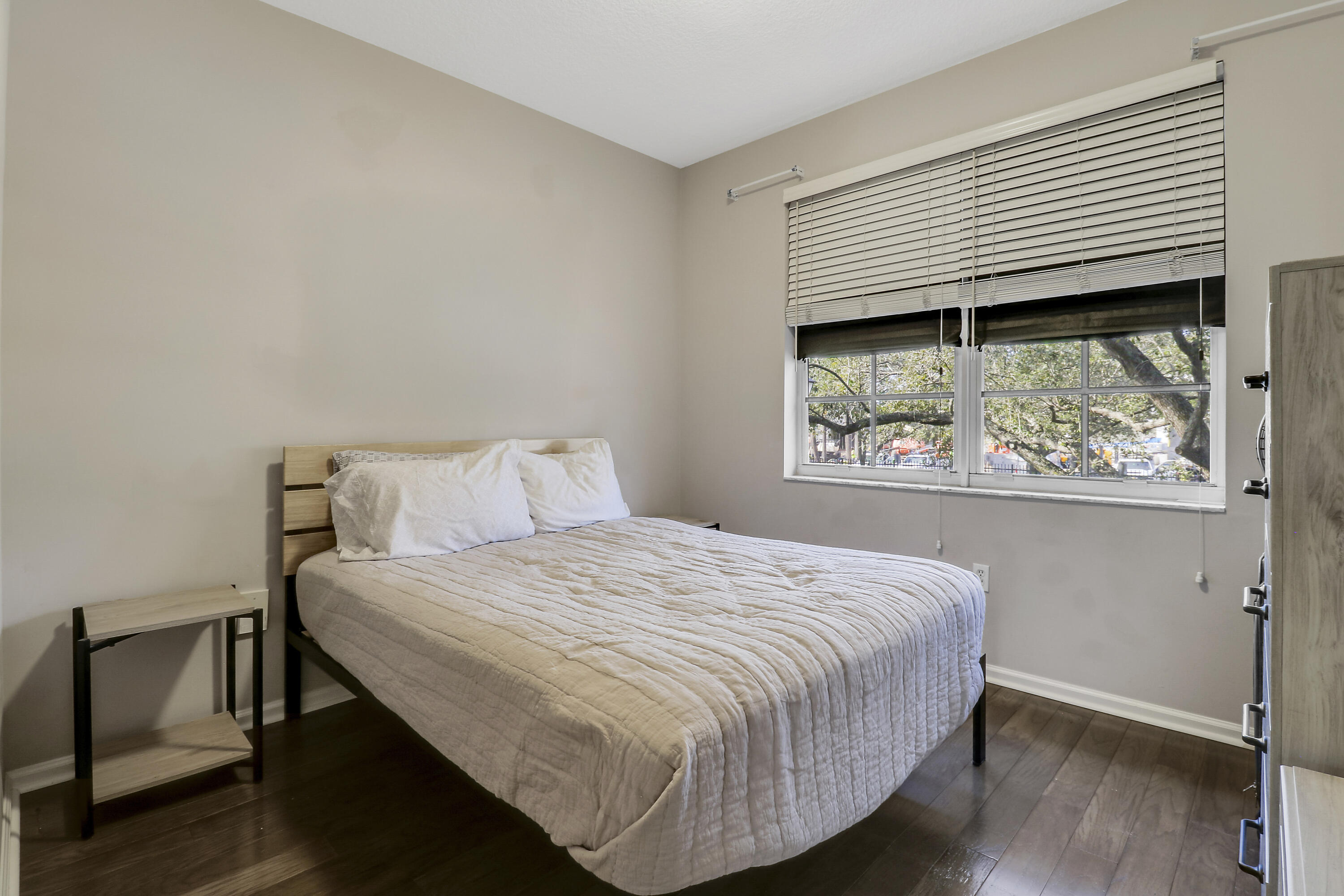 1152 University Boulevard, Unit 22 Jupiter, FL 33458 - Photo 17 of 24 a bedroom with a bed and a window