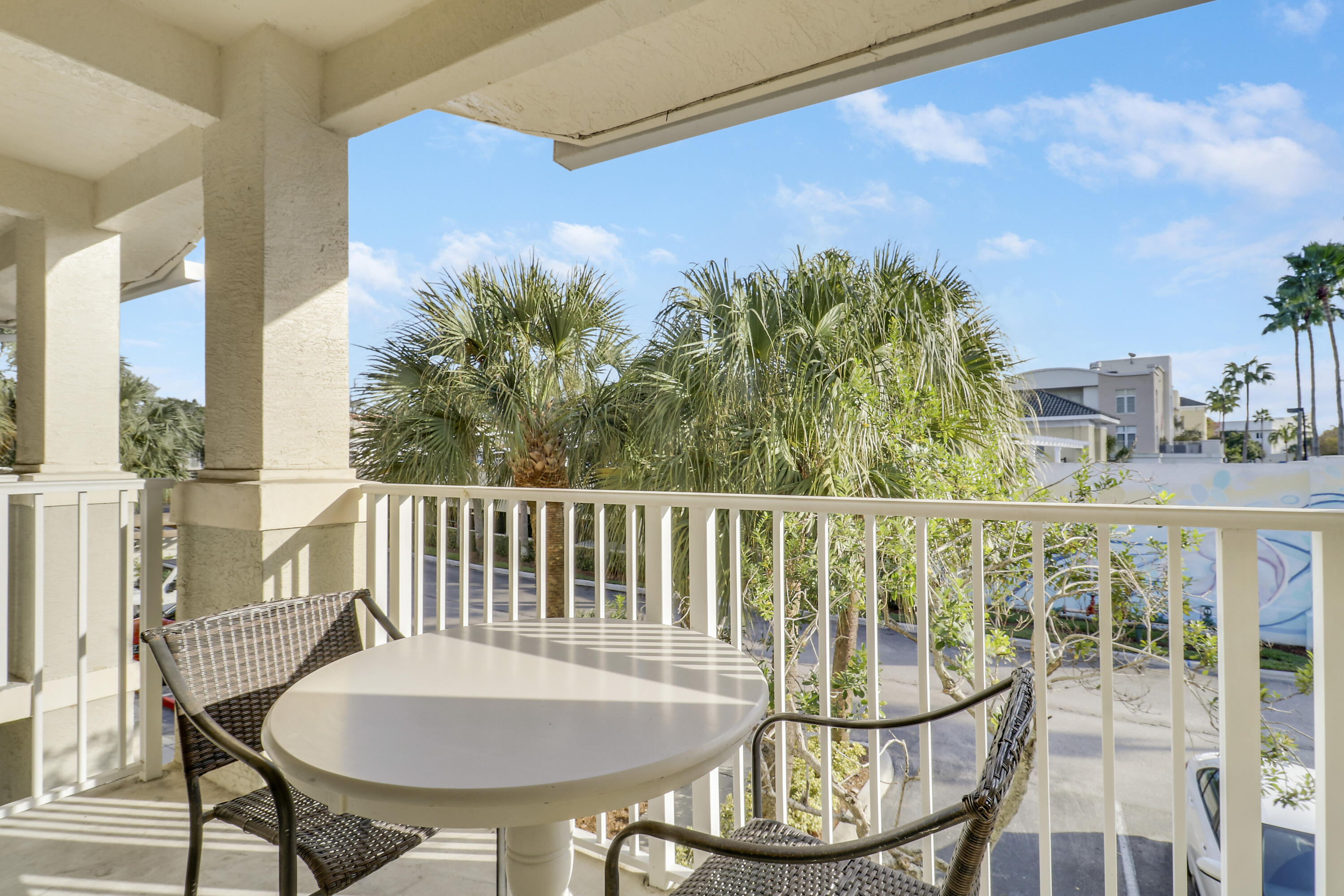 1152 University Boulevard, Unit 22 Jupiter, FL 33458 - Photo 19 of 24 a view of a balcony with chair and table