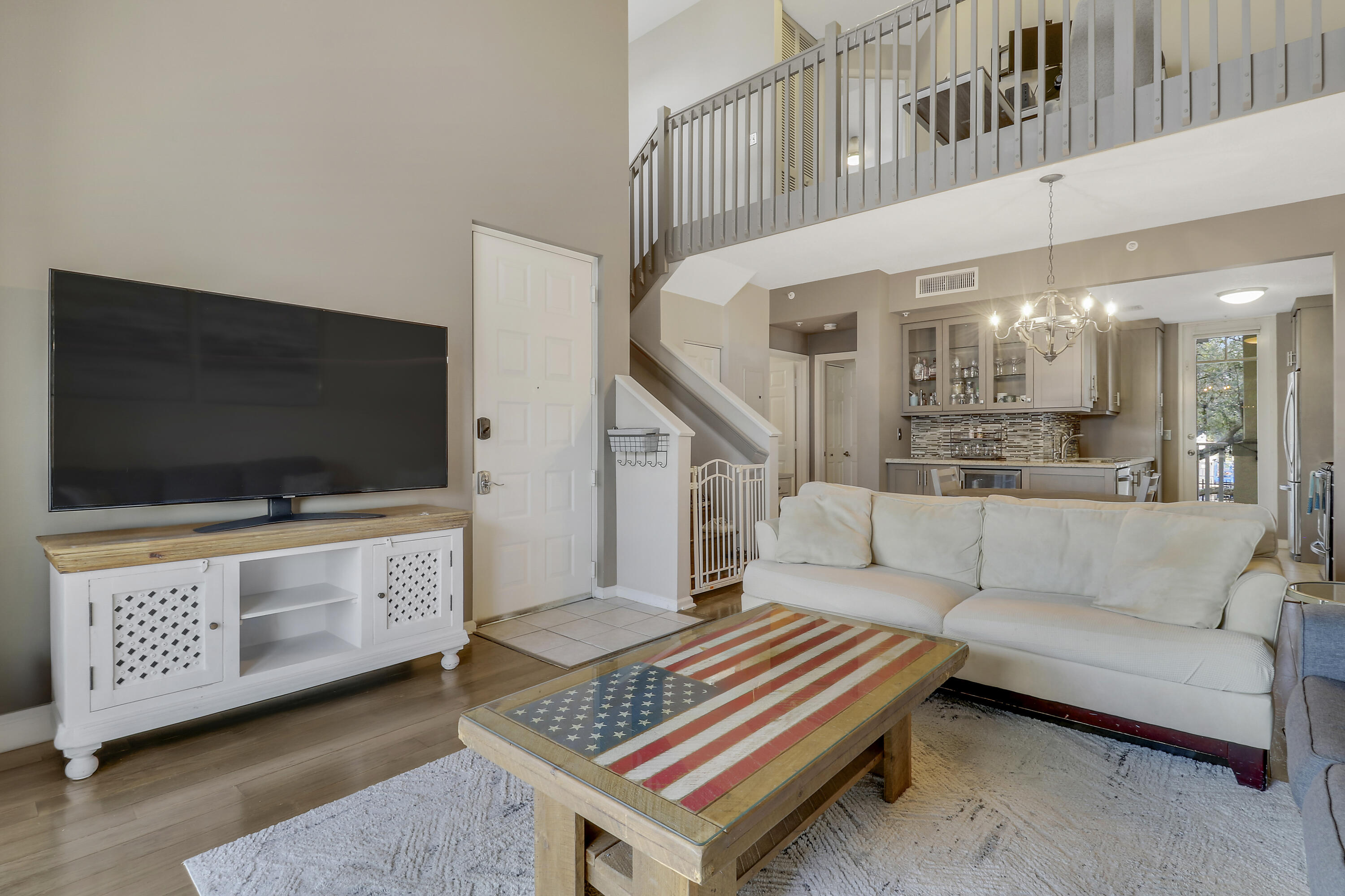 1152 University Boulevard, Unit 22 Jupiter, FL 33458 - Photo 2 of 24 a living room with furniture and a flat screen tv