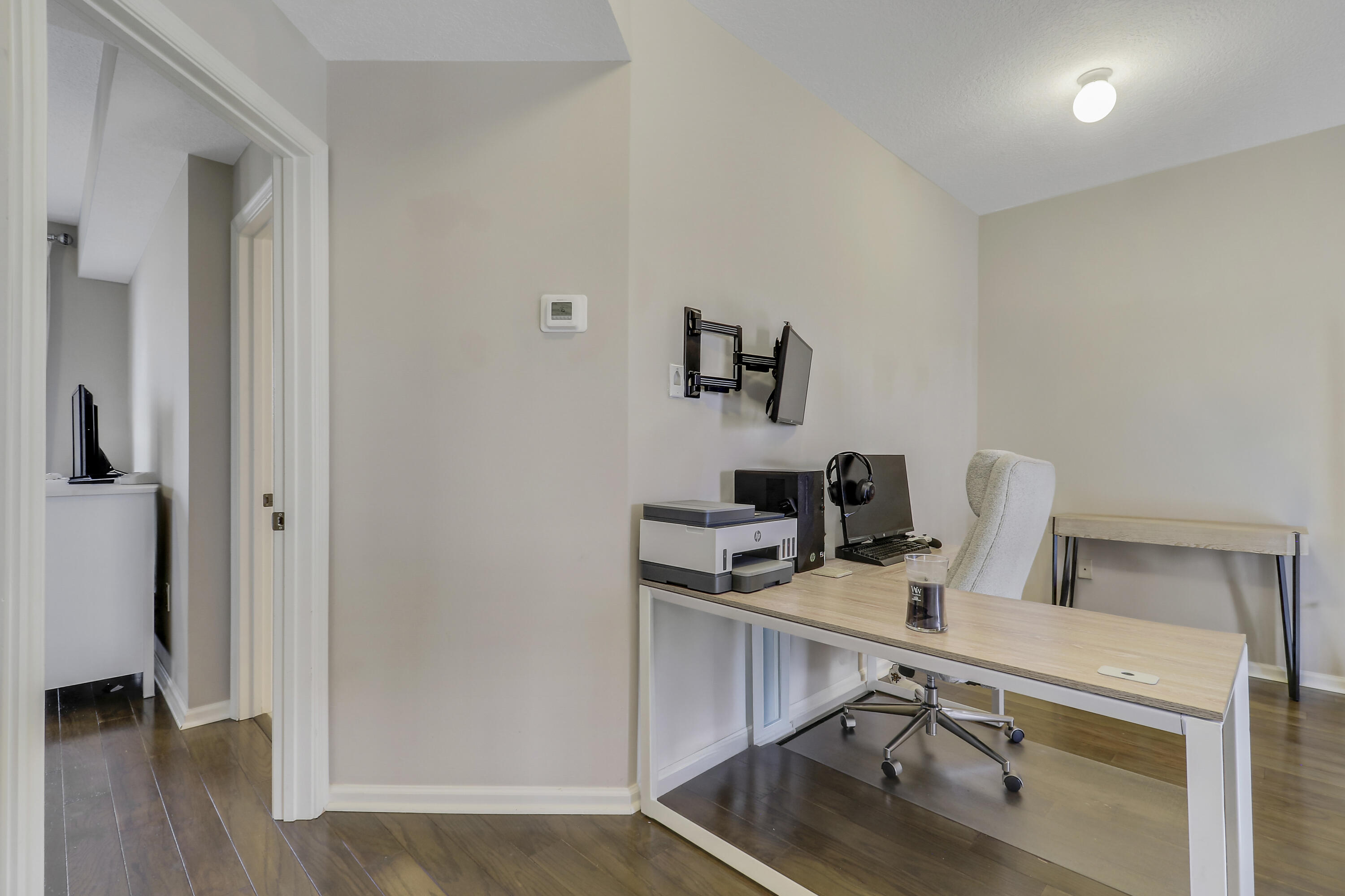 1152 University Boulevard, Unit 22 Jupiter, FL 33458 - Photo 22 of 24 a view of a workspace with furniture and wooden floor