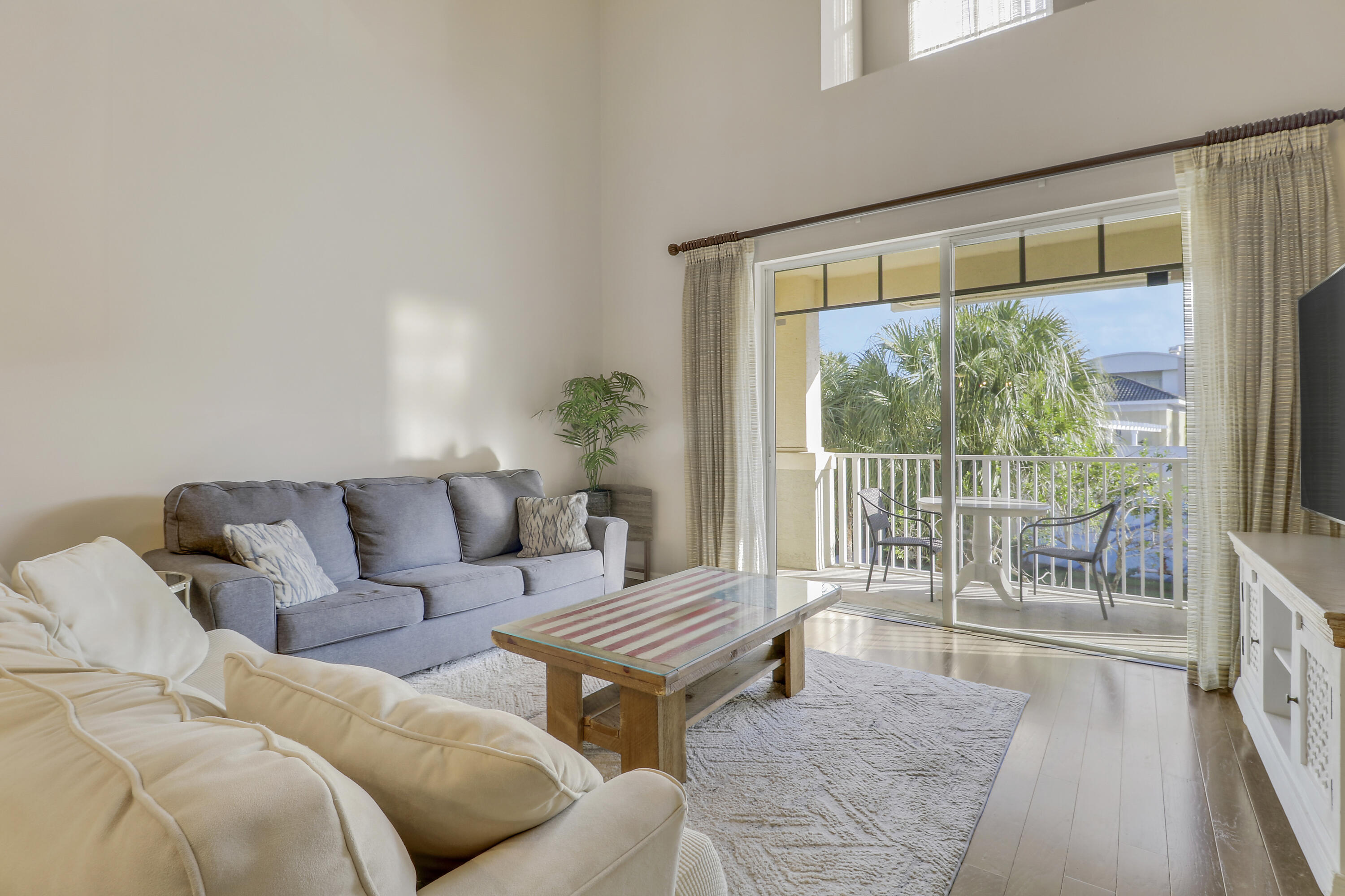 1152 University Boulevard, Unit 22 Jupiter, FL 33458 - Photo 5 of 24 a living room with furniture and a window with outer view