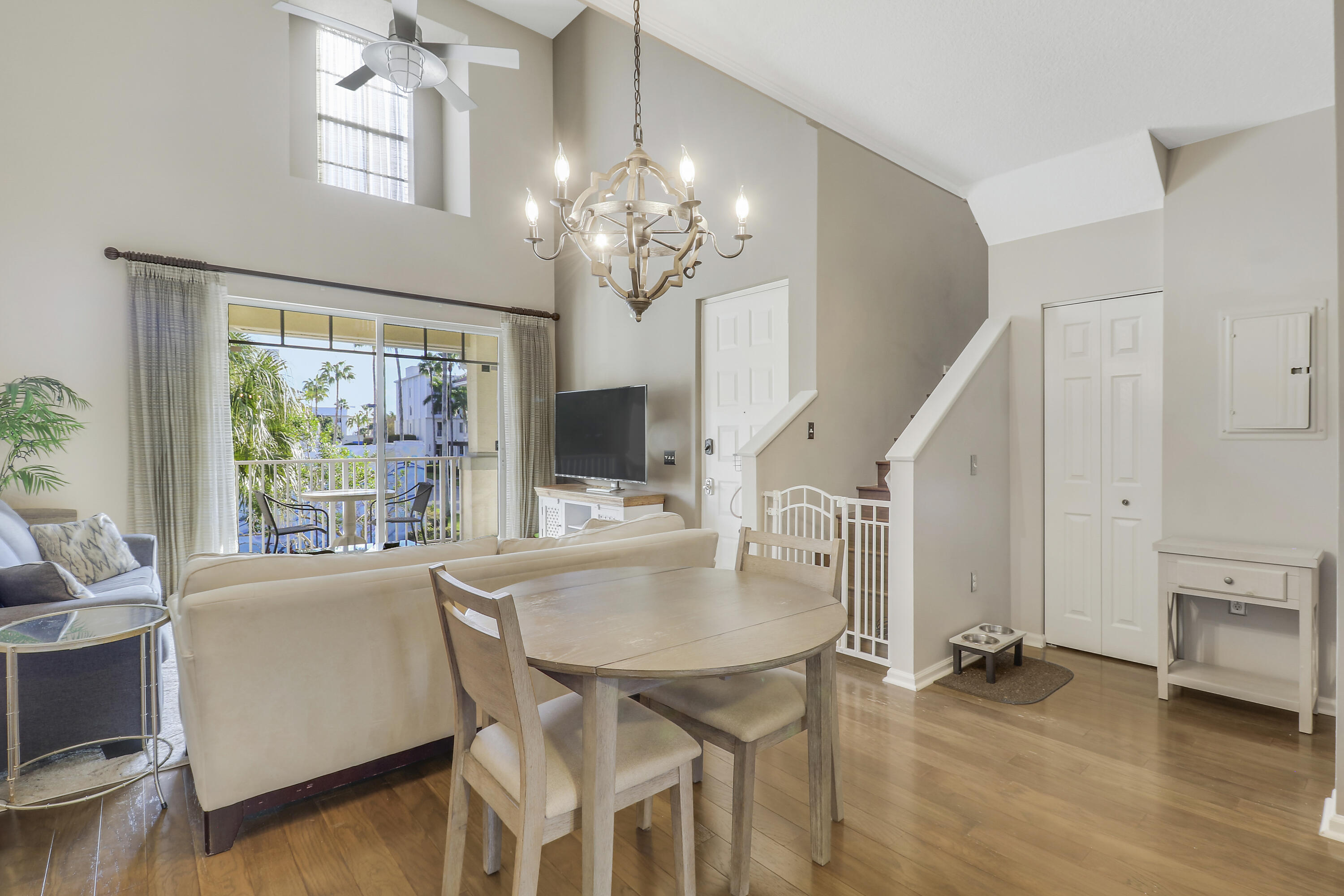 1152 University Boulevard, Unit 22 Jupiter, FL 33458 - Photo 6 of 24 a view of a dining room with furniture window and wooden floor