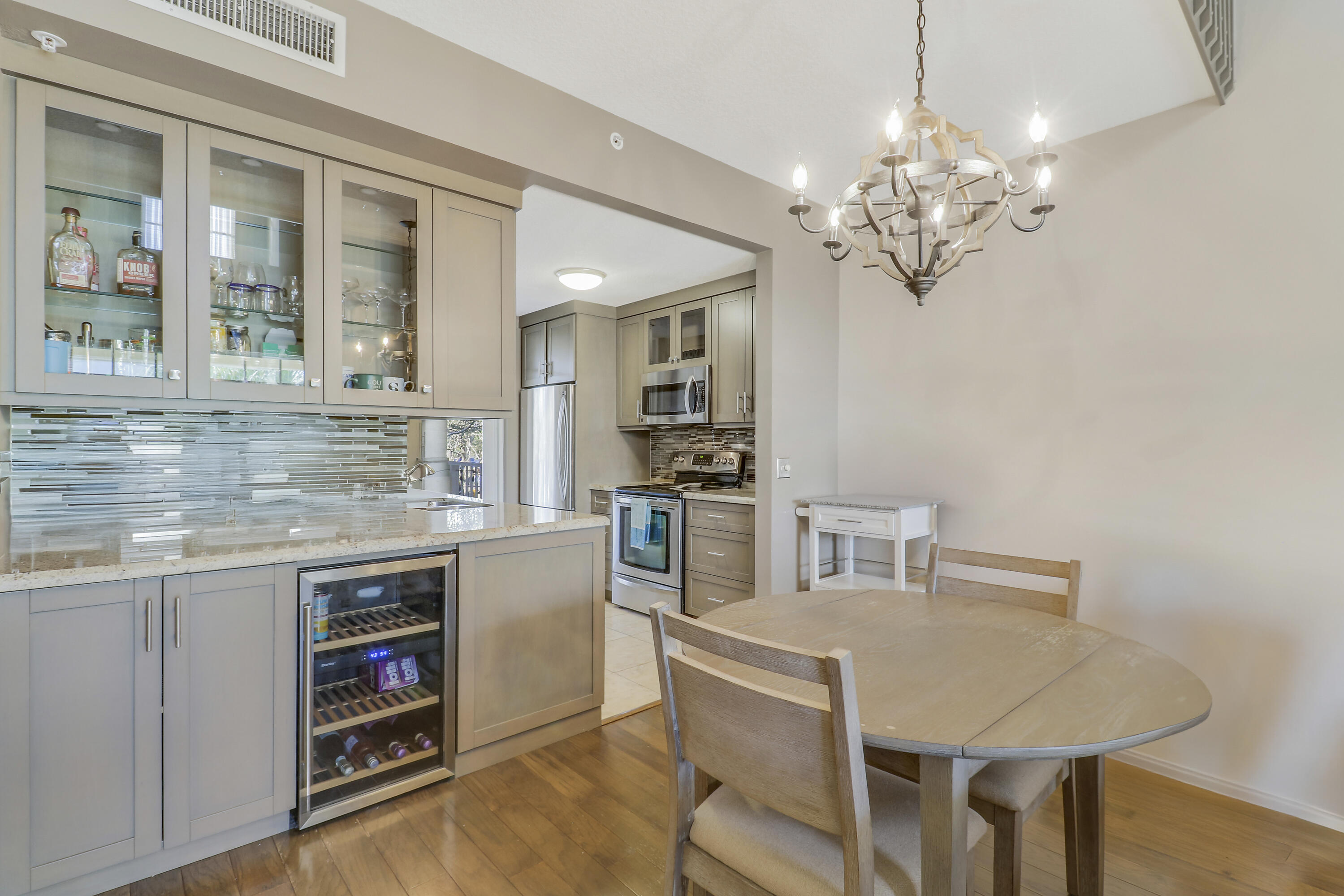 1152 University Boulevard, Unit 22 Jupiter, FL 33458 - Photo 8 of 24 a kitchen with a table and chairs in it