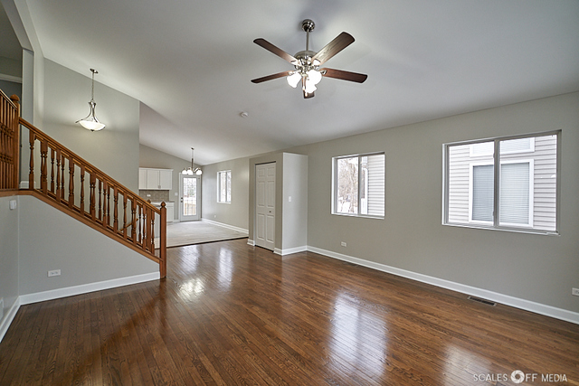 36692 North Stanton Point Road Ingleside, IL 60041 - Photo 3 of 29 a view of an empty room with wooden floor and a window