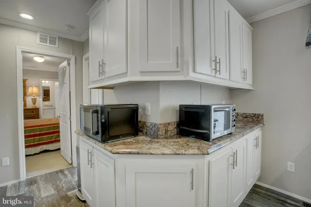 a kitchen with stainless steel appliances granite countertop a sink stove and microwave