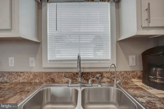 a kitchen with a sink and a window