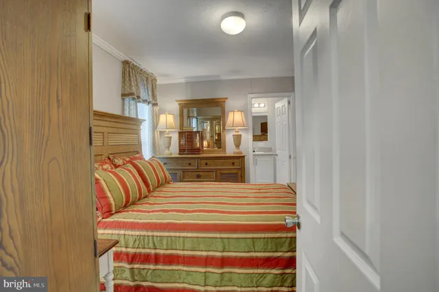 a bedroom with a bed and a mirror