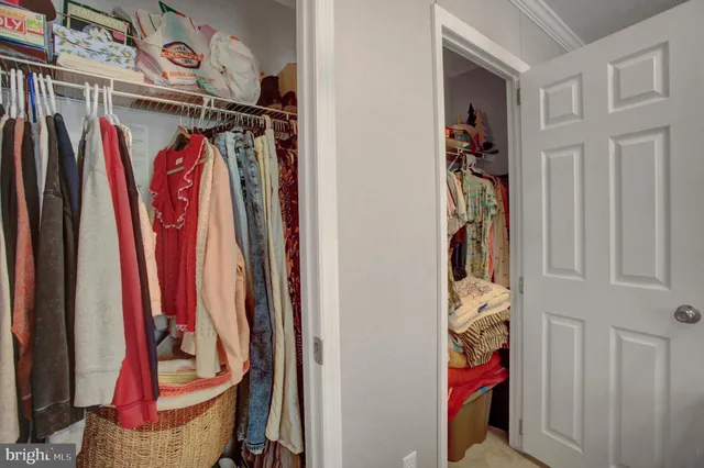a view of walk in closet with clothes