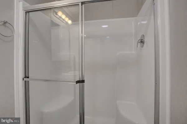 a bathroom with a glass shower door