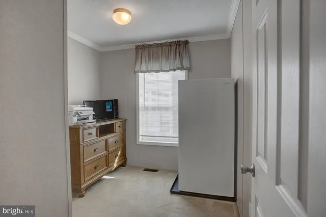 a room with a dresser and a window