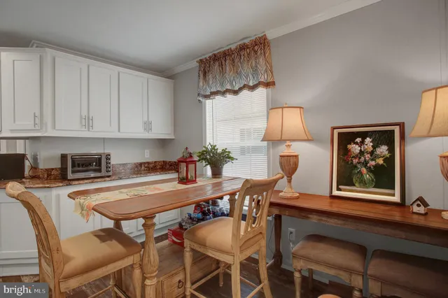 a view of a dining room with furniture and a chandelier