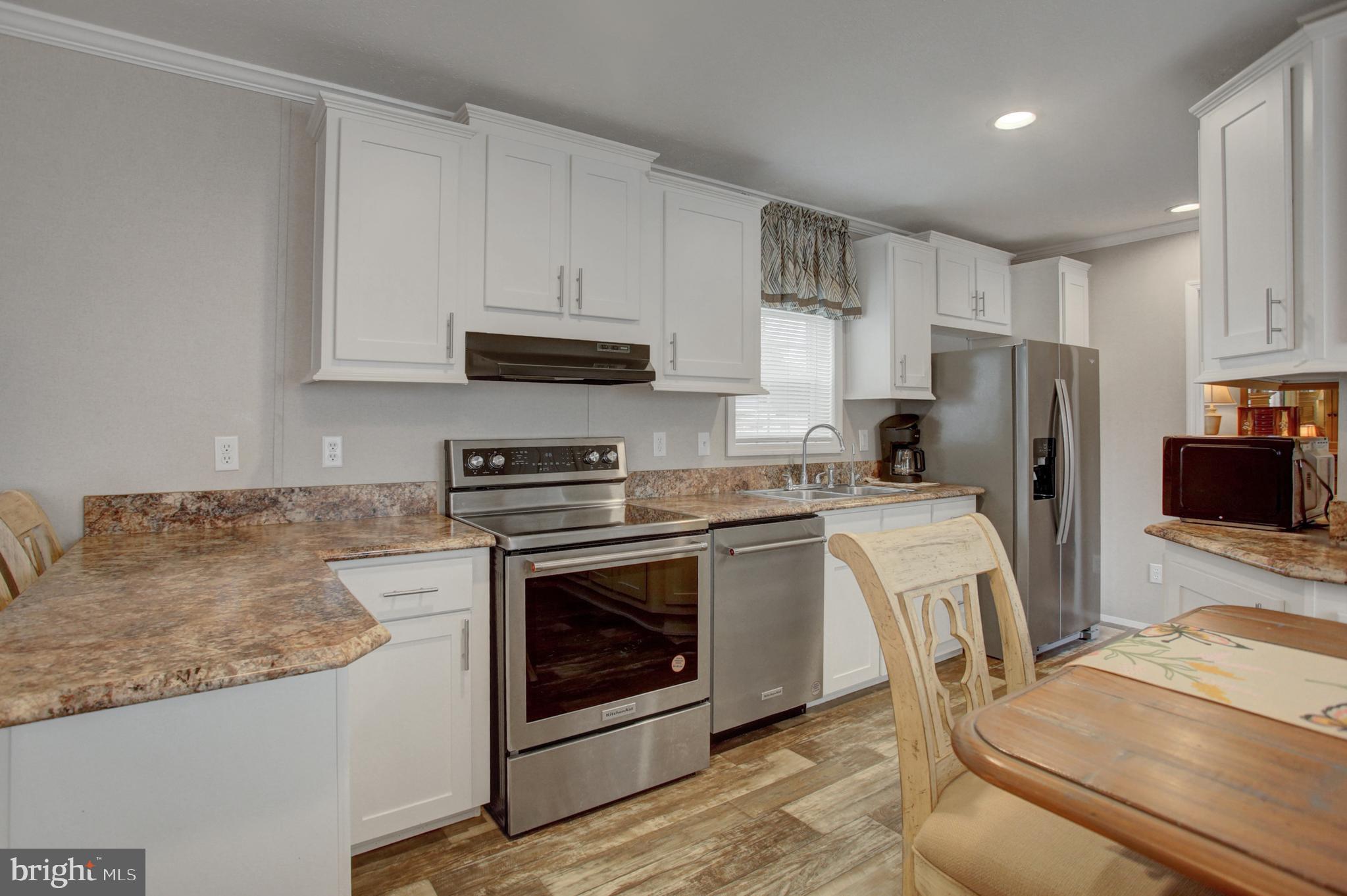 113 Big Spring Terrace Newville, PA 17241 - Photo 9 of 37 a kitchen with stainless steel appliances granite countertop a stove a refrigerator a sink a microwave and white cabinets