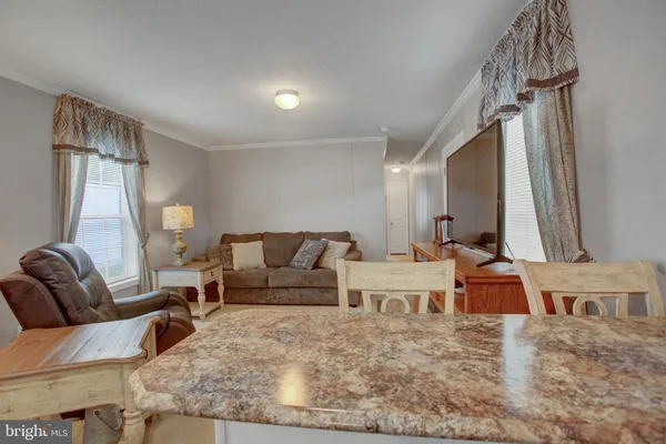a living room with furniture wooden floor and a chandelier