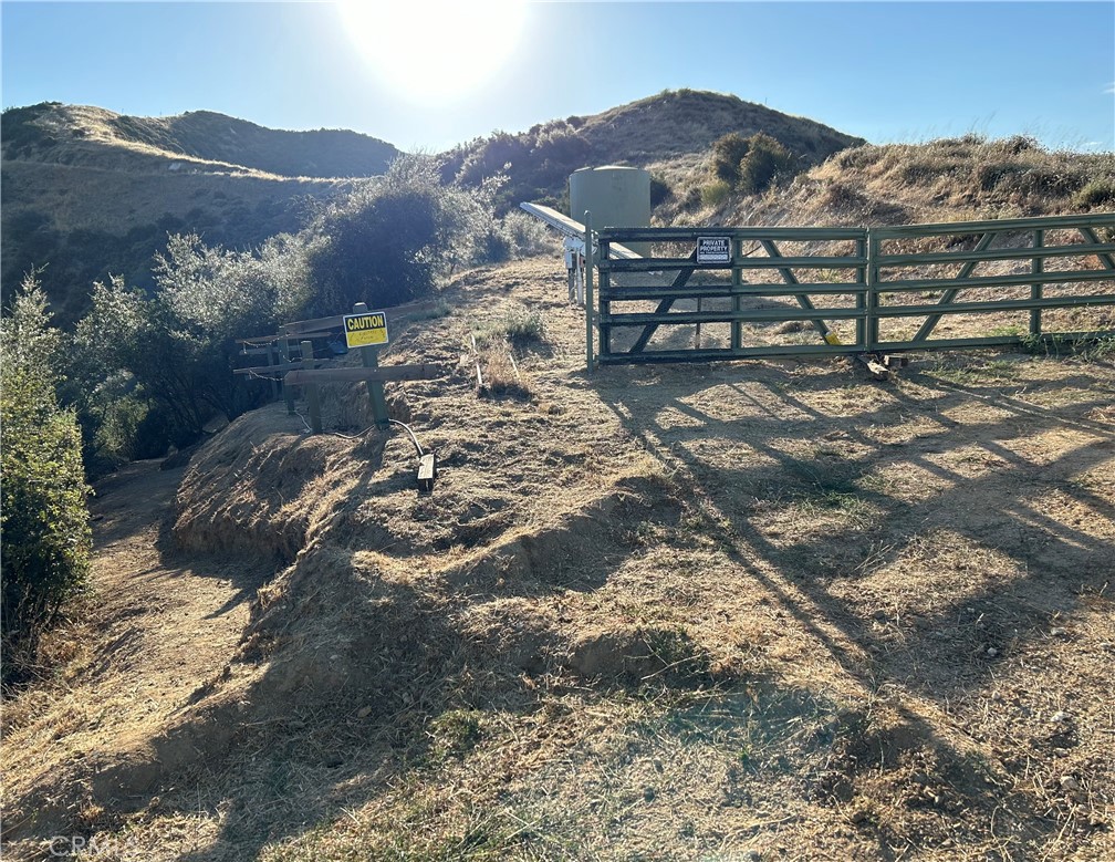 37342 Pisgah Peak Road Yucaipa, CA 92399 - Photo 2 of 6 a view of a lush green hillside and a houses