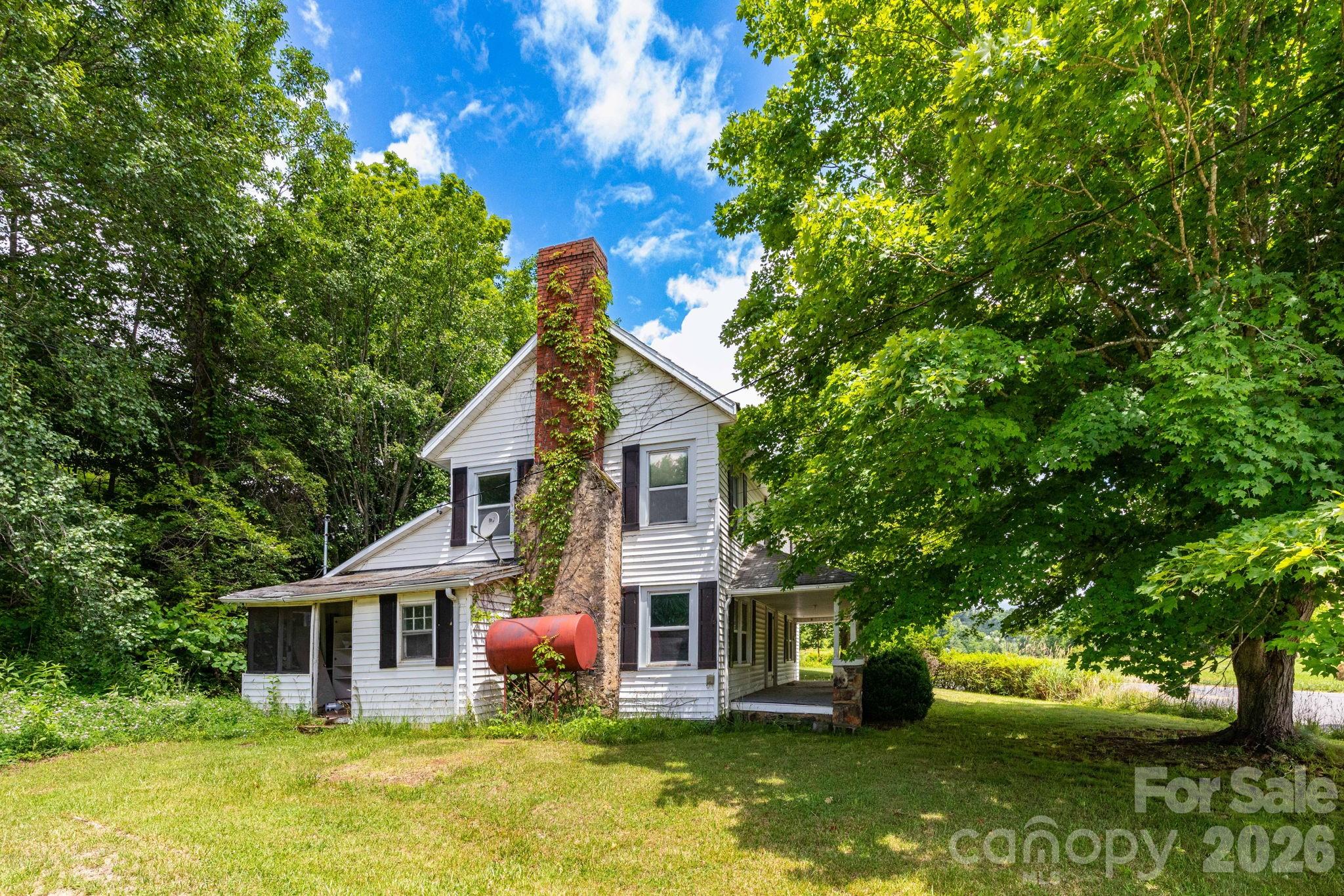 4085 Jacks Creek Road Burnsville, NC 28714 - Photo 5 of 24 a front view of a house with garden