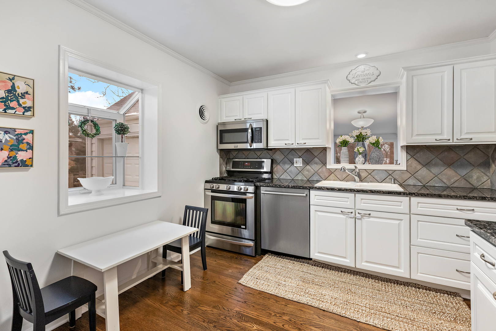 1207 Raleigh Road Glenview, IL 60025 - Photo 12 of 31 a kitchen with a stove a sink and a refrigerator
