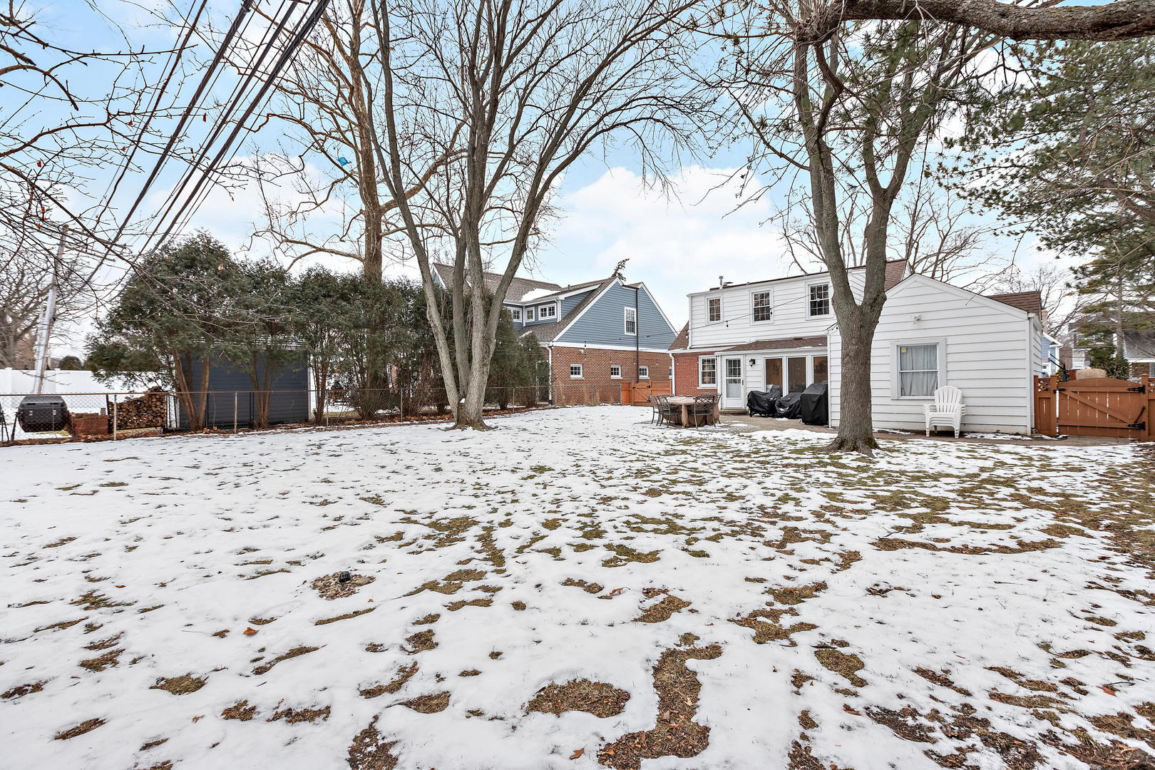 1207 Raleigh Road Glenview, IL 60025 - Photo 28 of 31 a front view of a house with a yard covered in snow