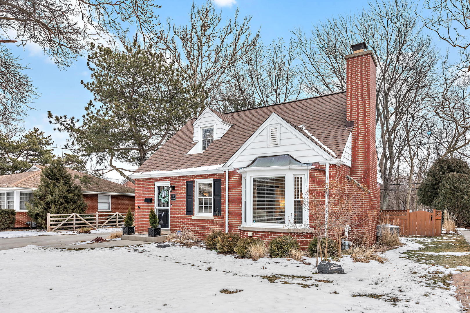 1207 Raleigh Road Glenview, IL 60025 - Photo 3 of 31 a front view of a house with a yard covered in snow