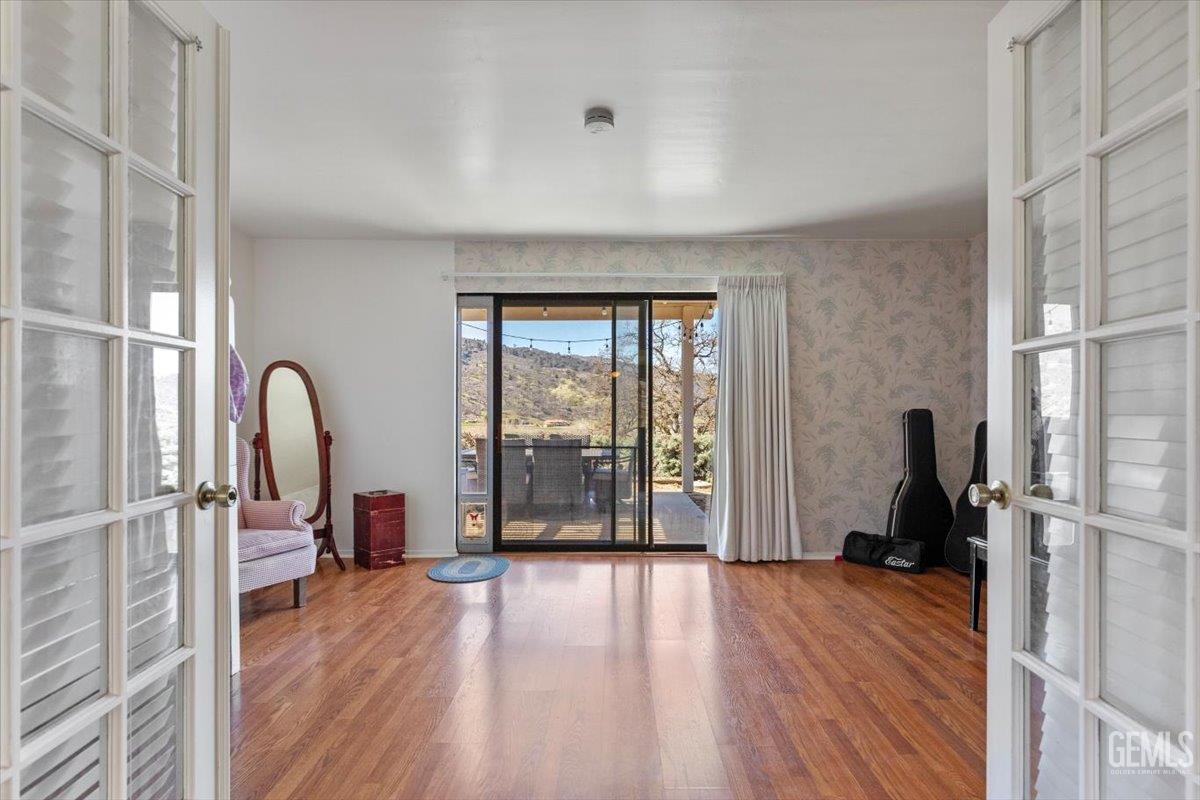 Undisclosed Address Tehachapi, CA 93561 - Photo 12 of 75 a view of a room with wooden floor and furniture