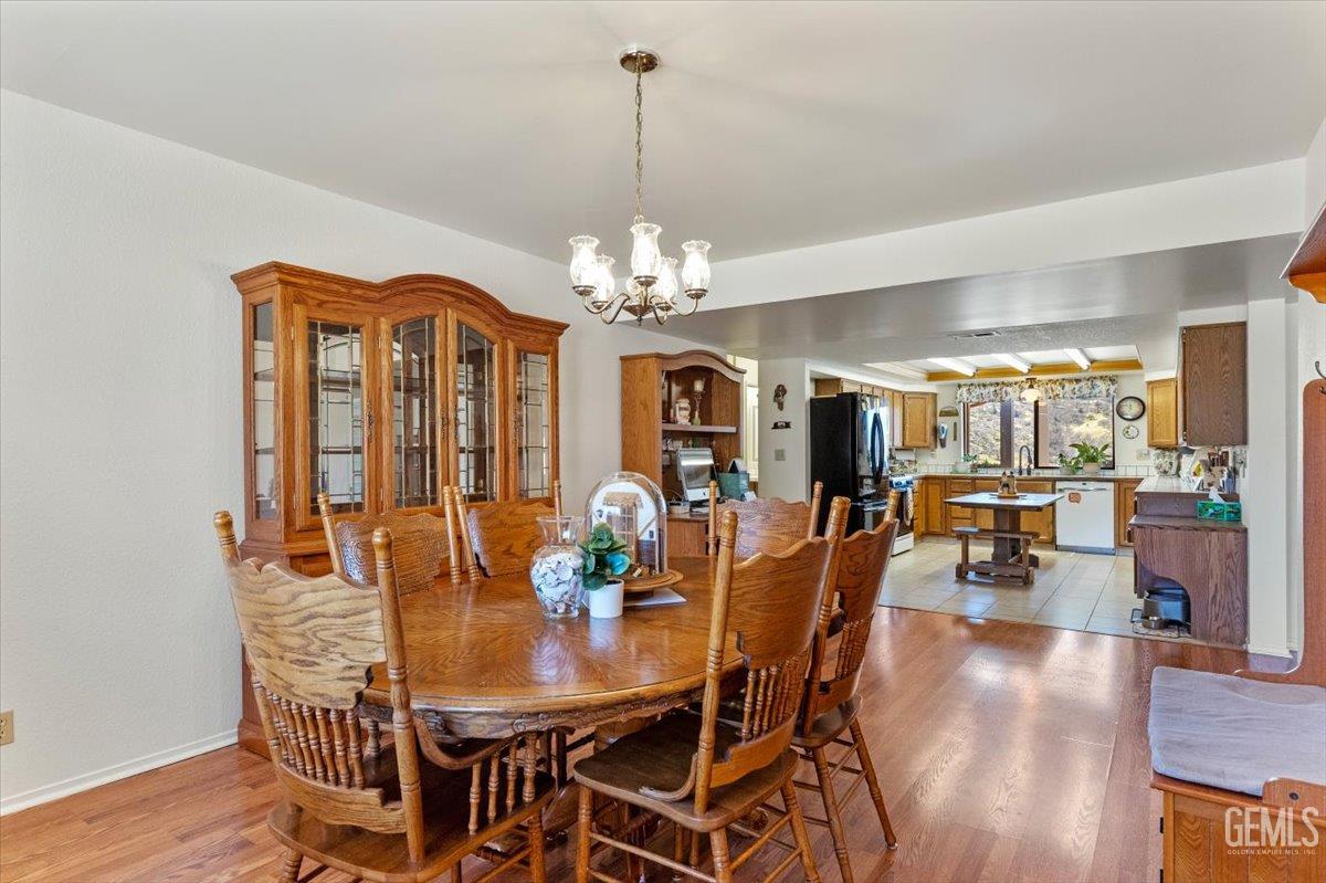 Undisclosed Address Tehachapi, CA 93561 - Photo 18 of 75 a view of a dining room with furniture and chandelier