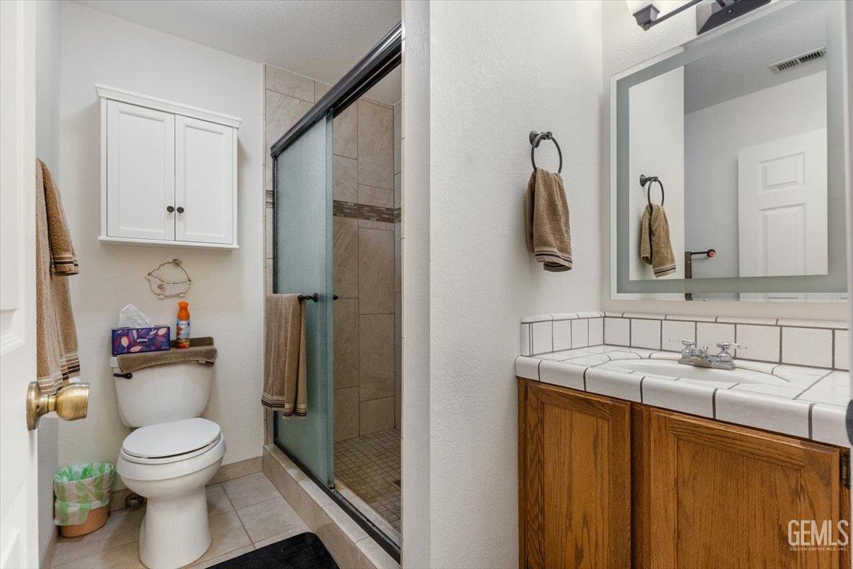 Undisclosed Address Tehachapi, CA 93561 - Photo 25 of 75 a bathroom with a toilet sink and mirror