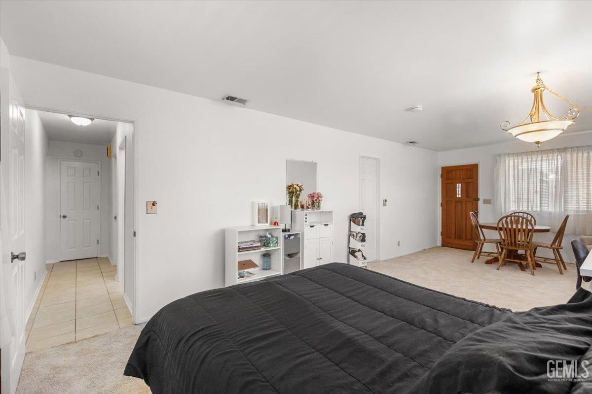 Undisclosed Address Tehachapi, CA 93561 - Photo 27 of 75 a bedroom with a bed and a chandelier