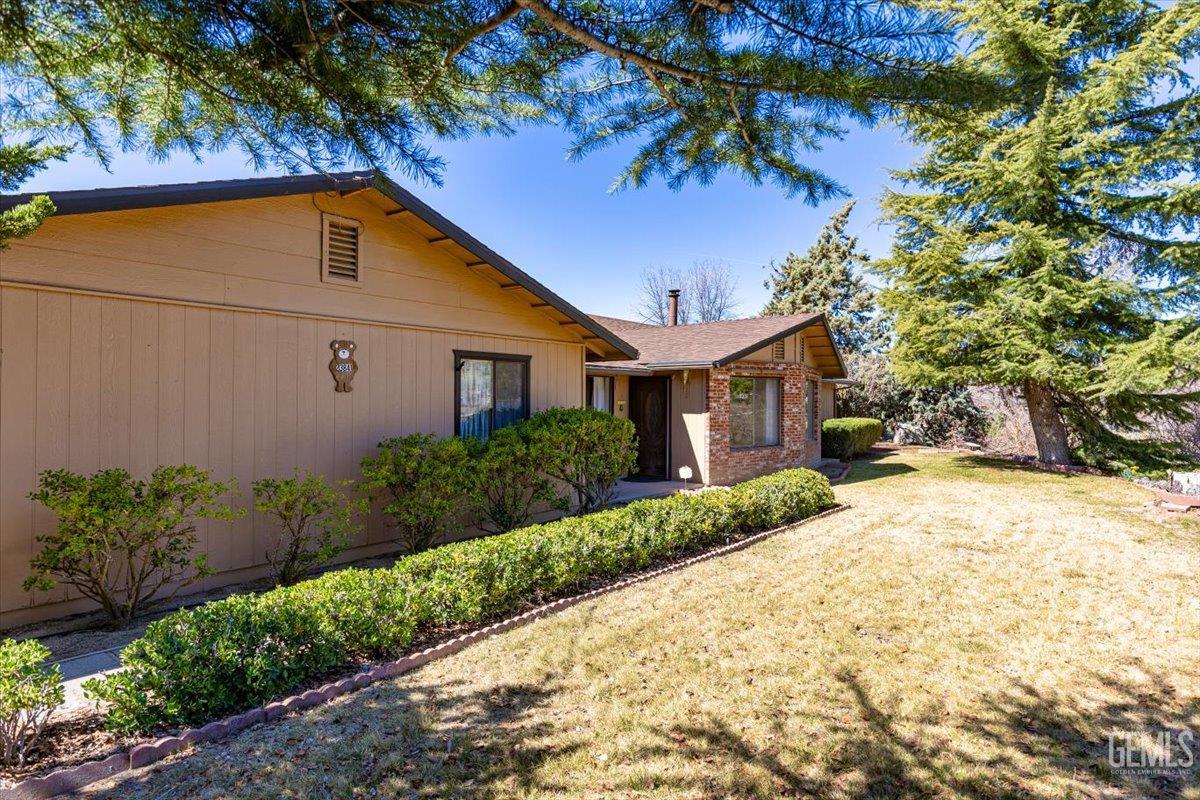 Undisclosed Address Tehachapi, CA 93561 - Photo 41 of 75 a front view of a house with a yard and garage
