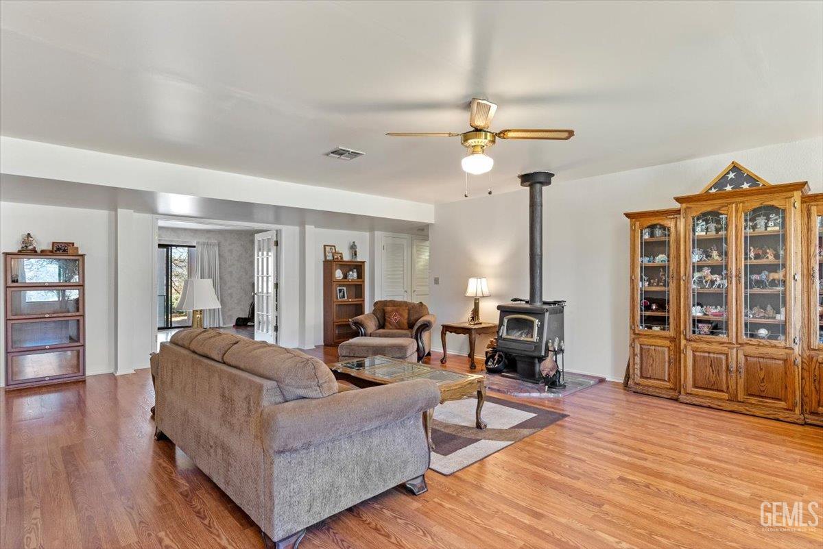 Undisclosed Address Tehachapi, CA 93561 - Photo 6 of 75 a living room with furniture a fireplace and wooden floor