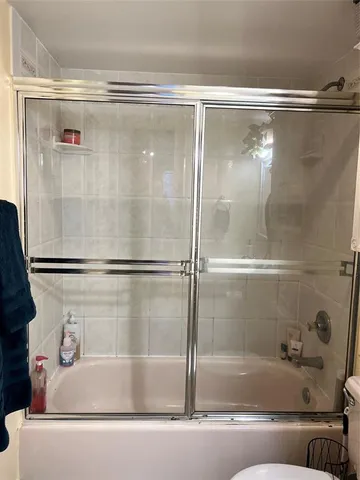 a bathroom with bathtub and a shower