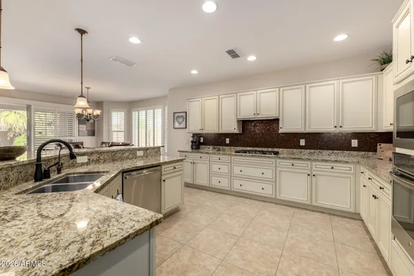 a large kitchen with a table and chairs