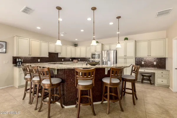 a large kitchen with a table and chairs