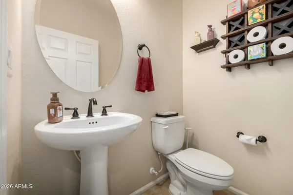 a spacious bedroom with a bed and a chandelier