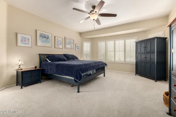 a spacious bedroom with a bed and a window