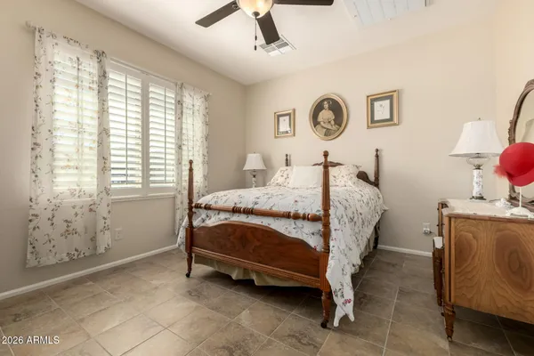 a bedroom with a bed and a ceiling fan