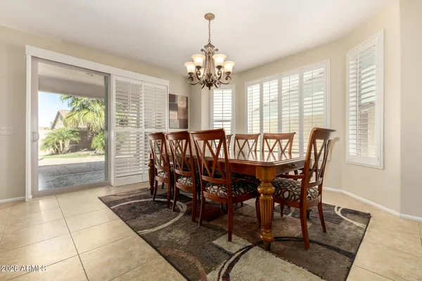 a kitchen with granite countertop a stove a sink a window and dining table