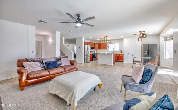 a living room with furniture and a chandelier