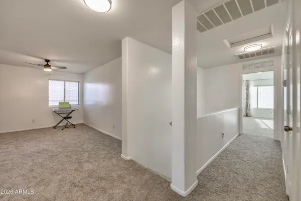 wooden floor in an empty room and a bathroom