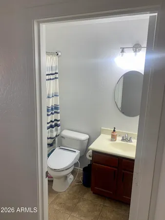 a bathroom with a sink toilet and mirror