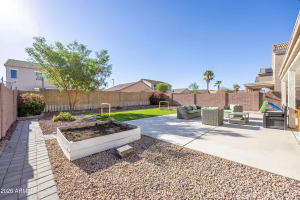 a view of a house with backyard and sitting area