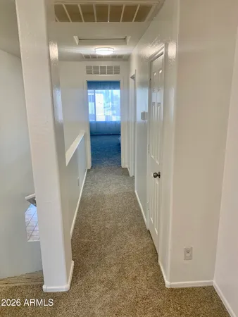 a spacious bedroom with a bed and a chandelier