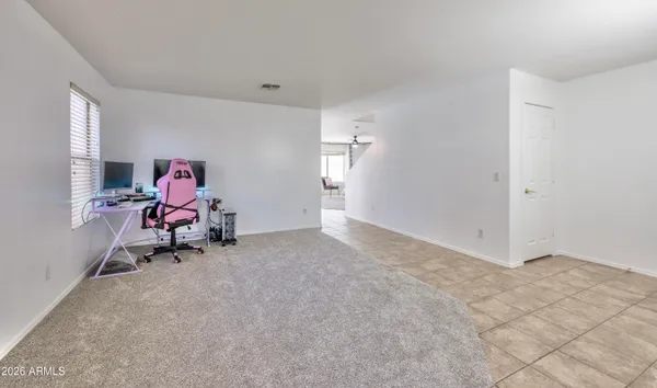 a living room with furniture and a gym machine