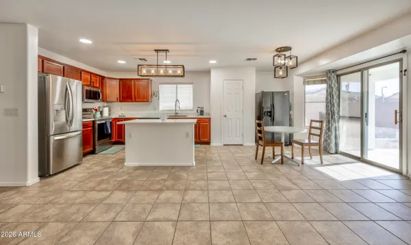 a kitchen with stainless steel appliances granite countertop a refrigerator and a stove top oven